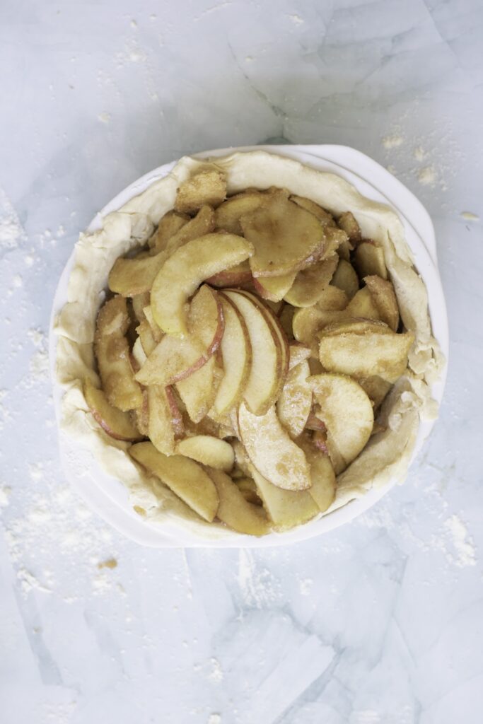 apple pie with apples in the crust before baking