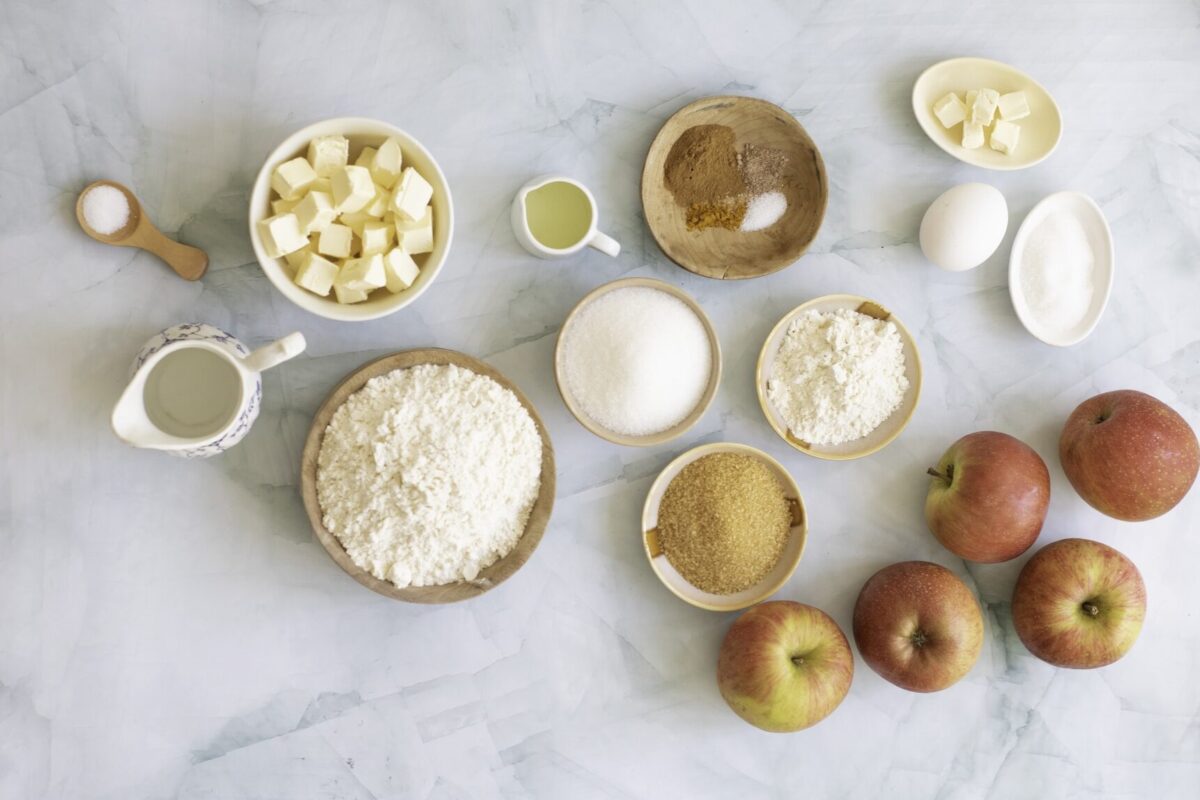 ingredients for an apple pie recipe in bowls