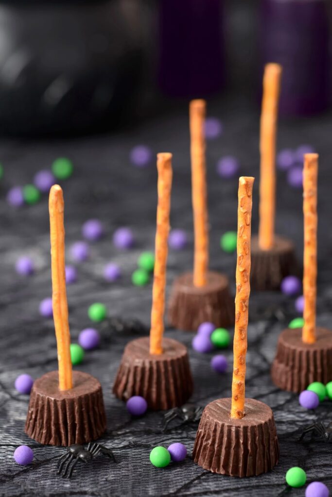 witch broom peanut butter cups, with pretzels stuck into peanut butter cups to look like brooms