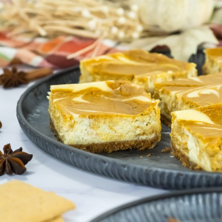 side view of pumpkin cheesecake bars on a plate