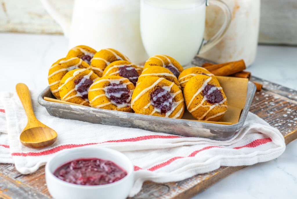 thumbprint cookies on a tray - gingerbread cookies with cranberry sauce filling