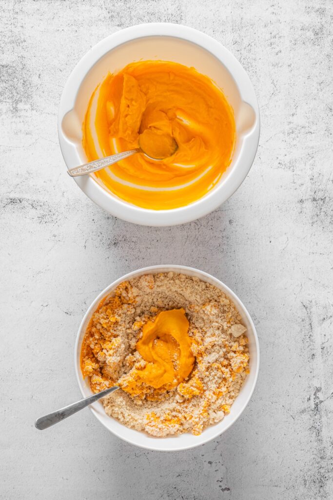 ingredients for pumpkin scones being mixed together between two bowls
