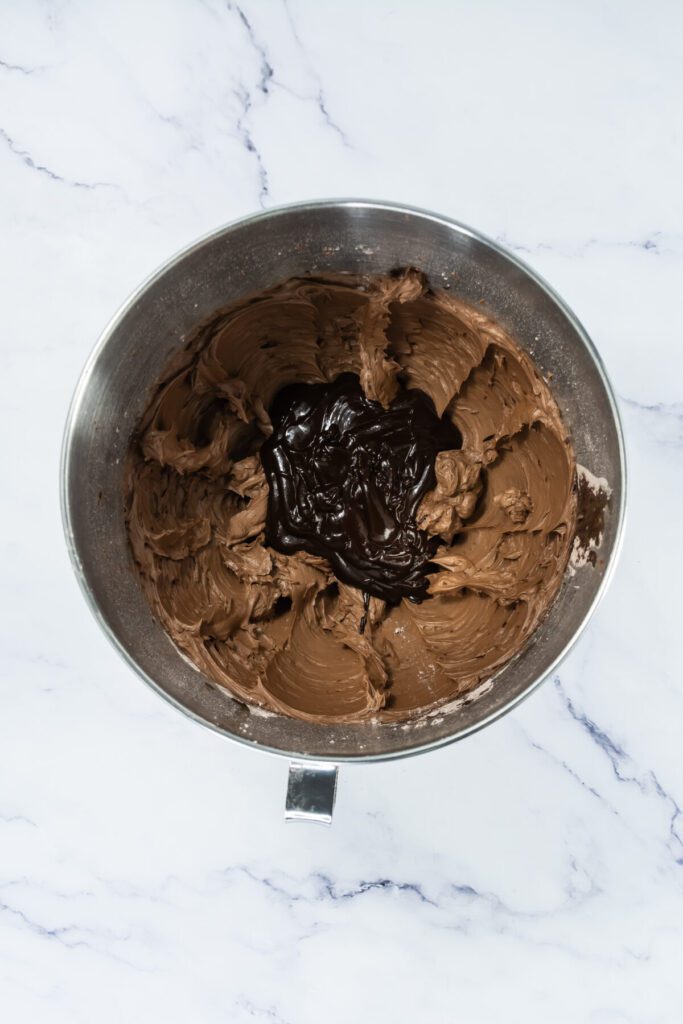 chocolate ganache in a bowl of mixed chocolate buttercream frosting