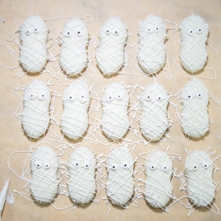 nutter butter mummy cookies on a parchment