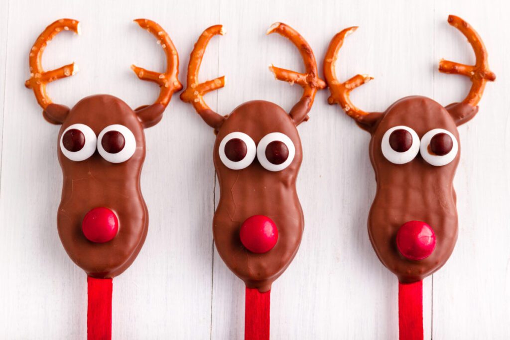 chocolate dipped nutter butters made into rudolph the red nosed reindeer