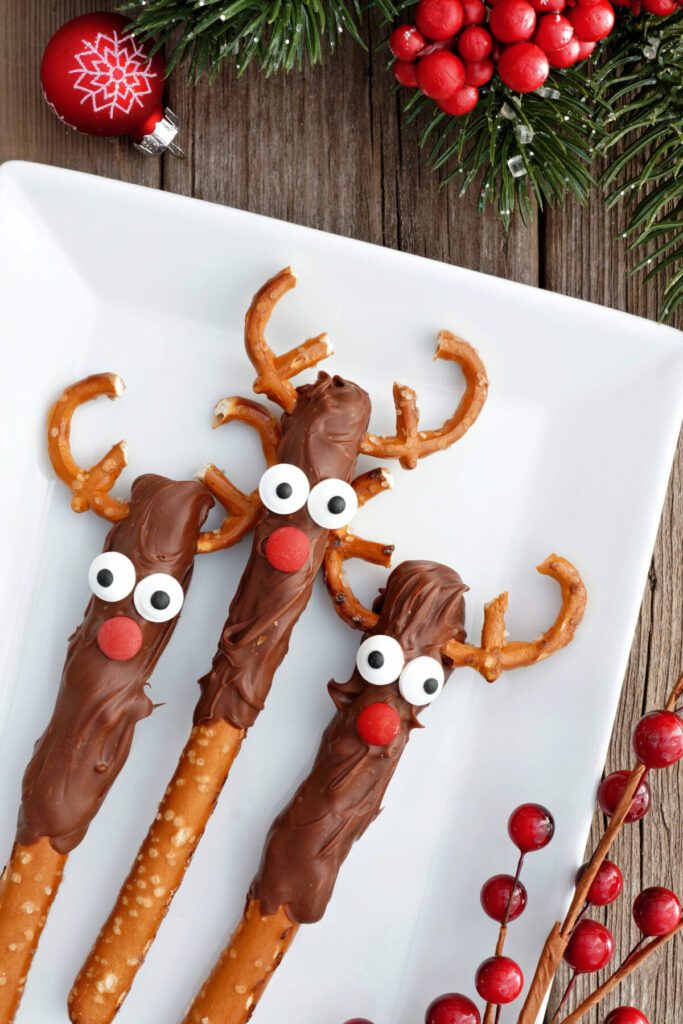 chocolate dipped pretzel rods made into rudolph the red nosed reindeer