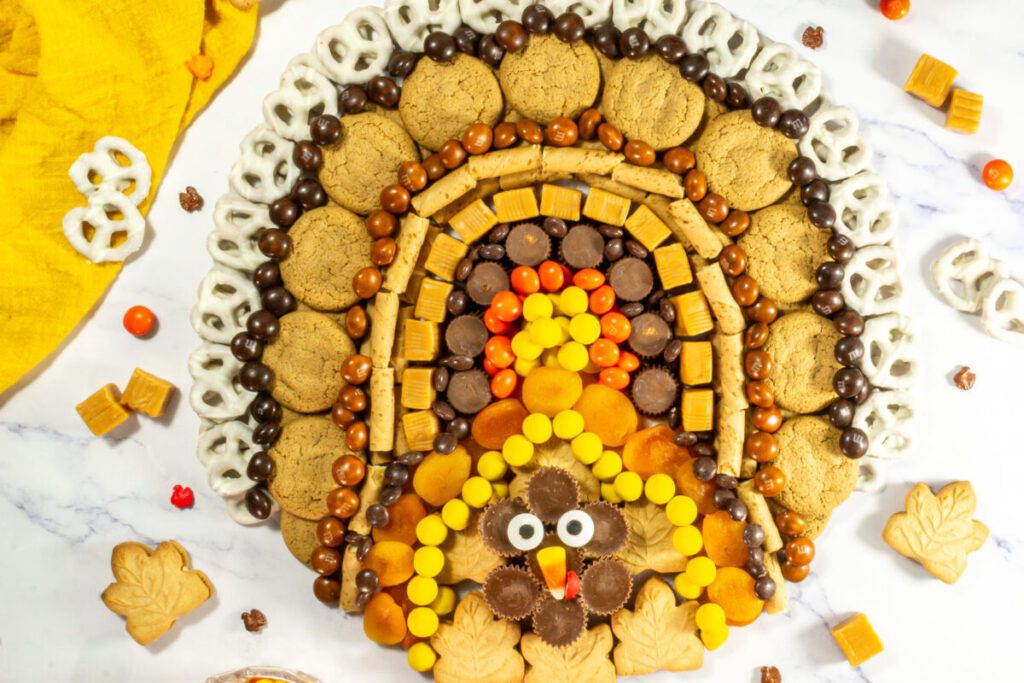 dessert thanksgiving charcuterie board made with cookies and candies that looks like a turkey